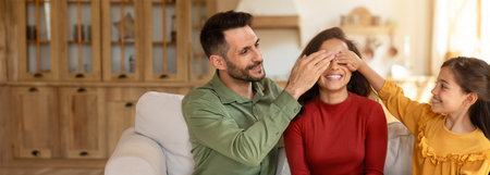 Family enjoying playful moment together in cozy living room at homeの写真素材