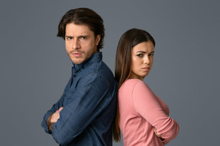 Relationship Crisis. Offended couple standing back to back with folded armsの写真素材