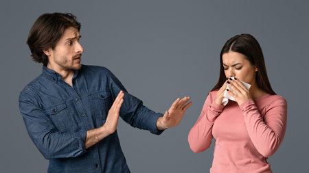 Virus Spread. Concerned young man keeping distance with his sick girlfriendの写真素材