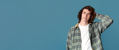 Serious young guy posing on color backgroundの写真素材