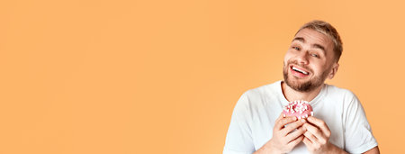 Sweet tooth man happy eat donut, panoramaの写真素材