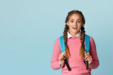 Surprised teenager girl with backpack, free spaceの写真素材