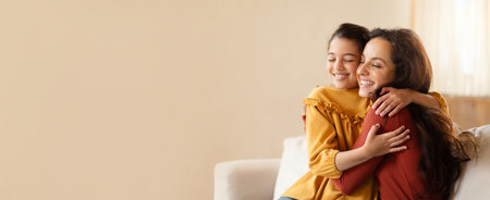 A mother and daughter share a warm embrace at home on a cozy afternoonの写真素材