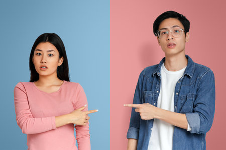 Couple in confrontation pointing fingers at each otherの写真素材