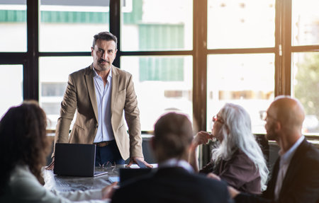 Business presentation in a modern room with an engaged audienceの写真素材