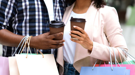 Unrecognizable Black Couple Resting With Coffee After Successful Shopping In Mallの写真素材