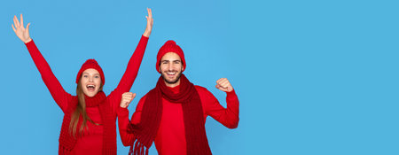 Holiday Spirit. Portrait Of Overjoyed Young Couple Wearing Winter Hats Celebrating Successの写真素材