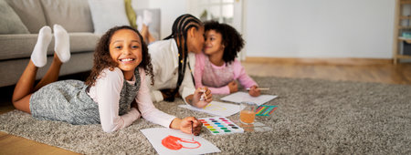 Joyful African American family have fun at home, painting