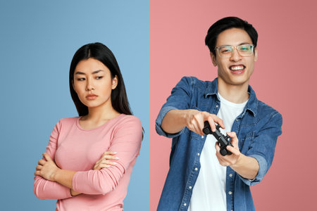 Asian guy playing video games while his girlfriend feeling lonely