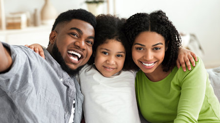 Family Selfie. Joyful Black Parents Taking Photo With Daughter At Homeの写真素材