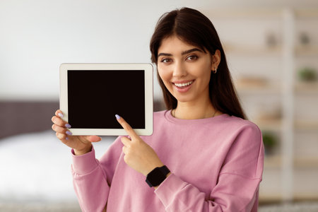 Woman showing blank empty tablet screen for mock upの写真素材