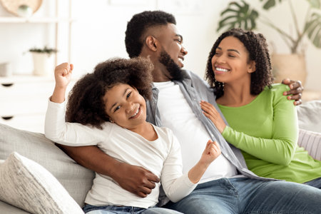 Happy Black Couple Enjoying Time At Home, Hugging And Having Fun Togetherの写真素材