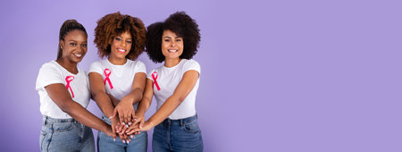 Three Black Ladies With Pink Ribbons Joining Hands, Purple Backgroundの写真素材