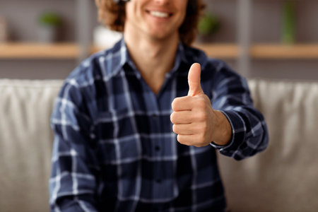 Guy Gesturing Thumbs-Up Approving Something Sitting At Home, Croppedの写真素材