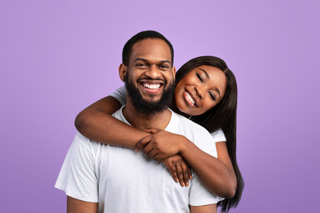 African American woman cuddling with her manの写真素材