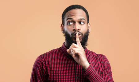 Funny black man making silence gesture with hand