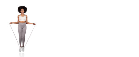 Jumping rope for fitness in a bright indoor space with a joyful expressionの写真素材