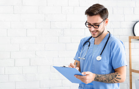 Happy vet doctor wtiting in clipboard at animal hospitalの写真素材
