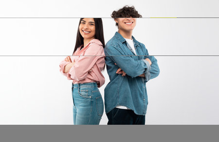 Cheerful Young Couple Crossing Hands In Confident Gesture, White Backgroundの写真素材