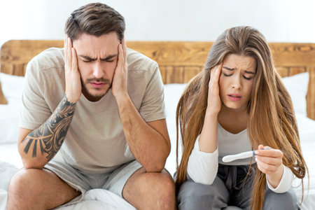 Sad husband and wife suffer from headaches and afraid of contracting coronavirus during epidemicの写真素材