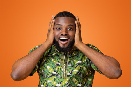 Amazed black man touching his head, yellow backgroundの写真素材