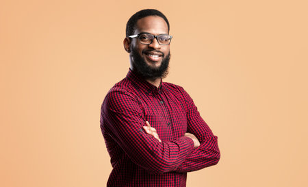 Smiling afro man posing on yellow backgroundの写真素材