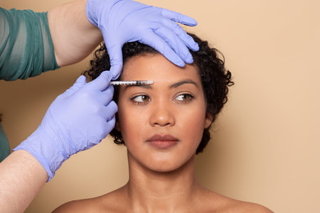 Professional cosmetic treatment in progress on a woman in a serene studioの写真素材