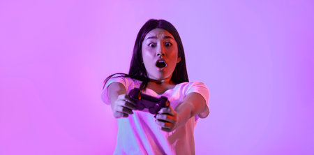 Real game. Surprised young woman with gamepad