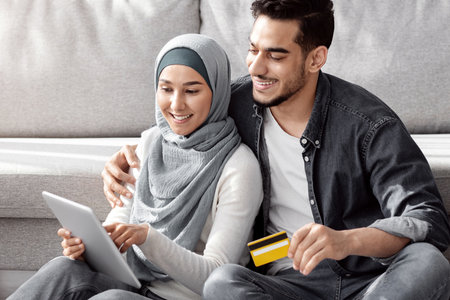 Smiling muslim family buying stuff for their new house
