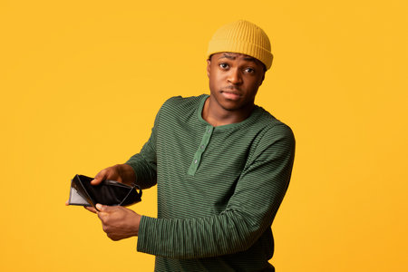 Poverty Concept. Upset Young Black Man Showing Empty Wallet At Cameraの写真素材
