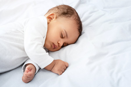 Little Baby Boy Sleeping Peacefully Lying In Bed Indoorsの写真素材