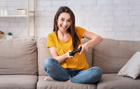 Home entertainment. Happy lady with joystick playing online computer games indoors