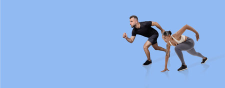 Couple engages in dynamic workout on a solid color backgroundの写真素材