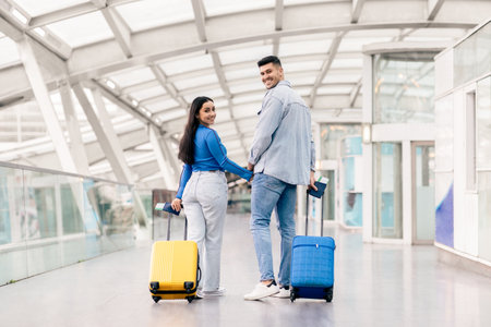 Young couple enjoying their travel adventure at the airport togetherの写真素材