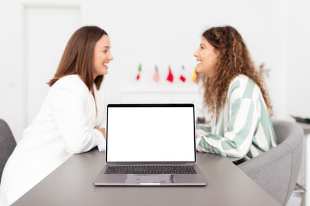 Business meeting between two millennial women in a corporate office settingの写真素材