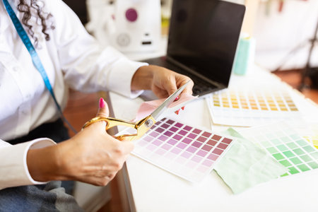 Creative designer working on fabric samples in a bright office studio