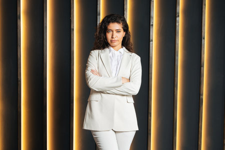 Confident businesswoman poses in modern office environment