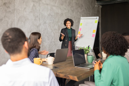 Diverse team collaborates in a corporate meeting room for project successの写真素材