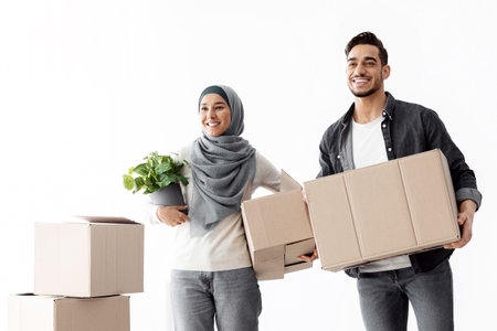 Excited arabic couple moving to new apartment, full length photo