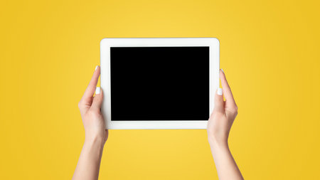 Cropped view of millennial girl showing tablet computer with mockup for design on screen against...