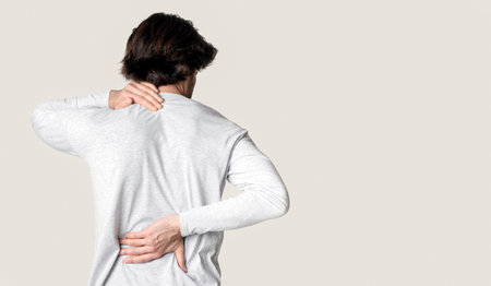 Man suffering from back and neck painの写真素材