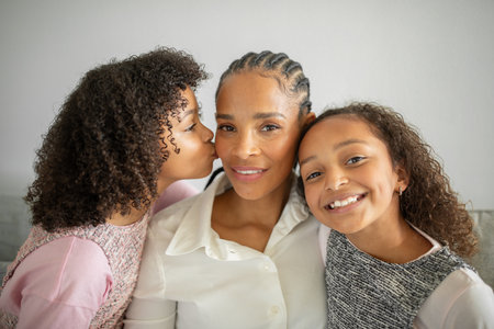 Family bonding moments with daughters at home filled with love and affectionの写真素材