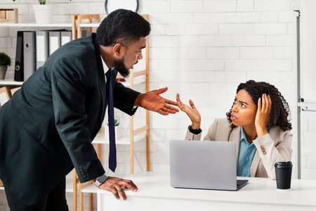 African American coworkers arguing with each other at officeの写真素材