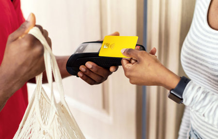 Unrecognizable Black Female Receiving And Paying For Delivered Groceries Indoorsの写真素材