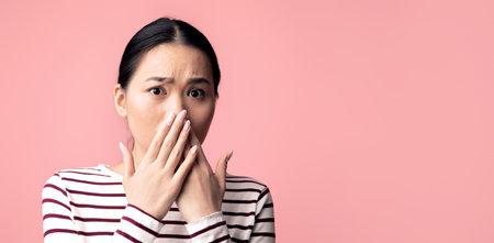 Oh No. Portrait Of Shocked Asian Woman Covering Mouth With Hands