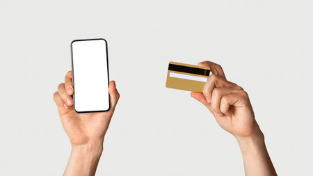 Online shopping. Unrecognizable man holdng credit card and smartphone with empty screen, space for...