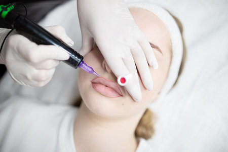 Woman enjoying pampering session for long-lasting permanent makeup at salonの写真素材