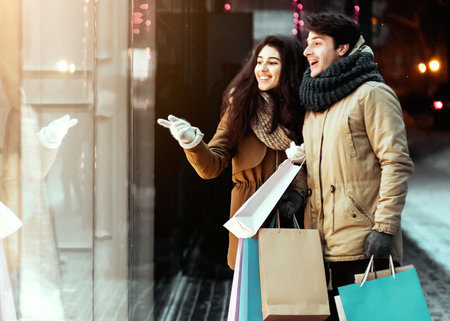 Girl Pointing At Shopwindow Shopping With Boyfriend In City, Panoramaの写真素材