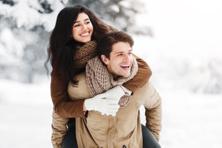 Boyfriend Carrying Girlfriend Piggyback Having Fun In Winter Forest, Panoramaの写真素材