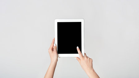Female hand touching blank screen of tablet computer on white background, mockup for your design